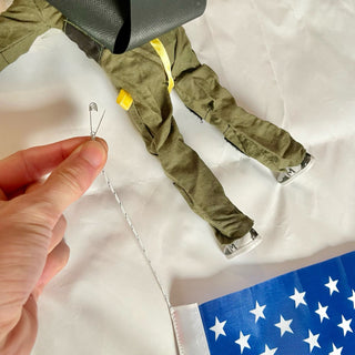 Skydiver legs with display flag pin.