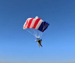 RC skydiver flying in the blue sky.