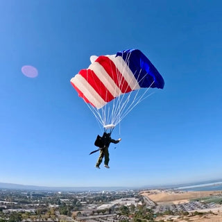 USA flag toy parachute high in the sky.