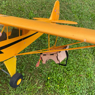 Parachute dropping system under rc plane wing.