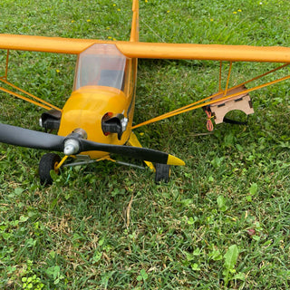 Parachute dropping system under piper j3 cub rc plane wing.