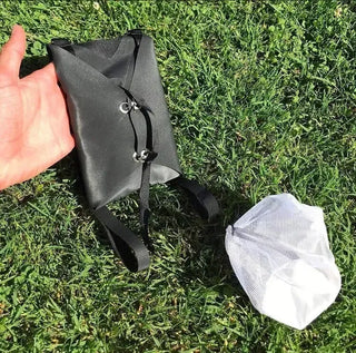 Container with harness on the grass.
