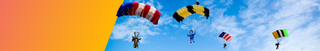 Colorful parachutes in the blue sky.